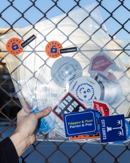 Hands hold two vinyl records in PVC sleeve