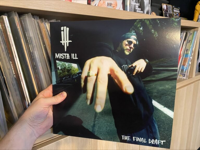 a hand holding a vinyl