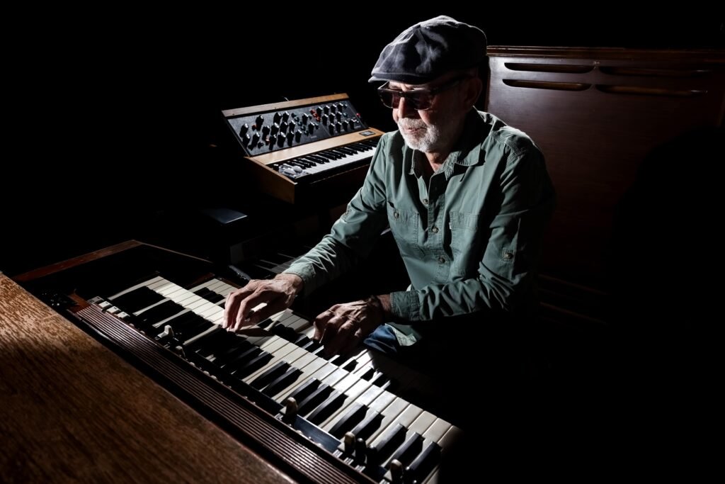 Soul Sugar playing a Hammond B3 organ with a Moog synth beside him