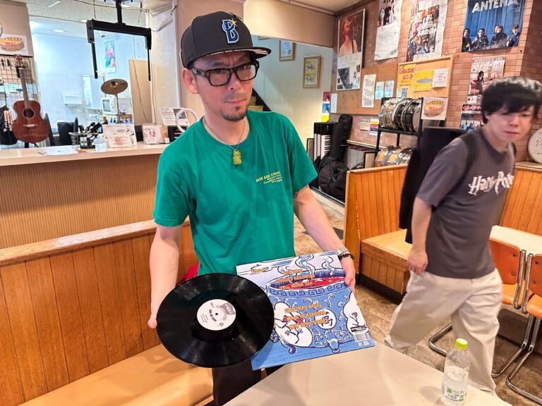 Green Flyers band member showing the vinyl record and cover