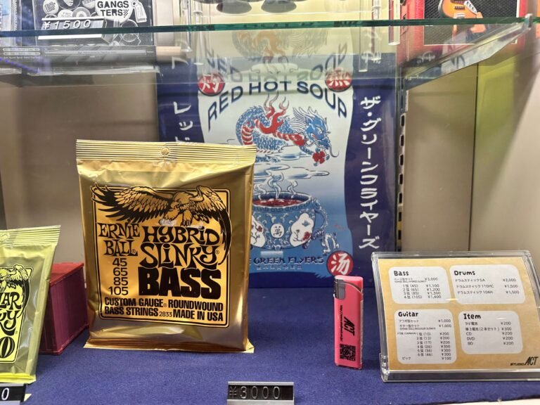 Red Hot Soup vinyl behind glass in music store, next to guitar and bass strings