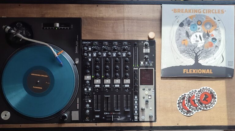 Technics turntable with turquoise vinyl, Denon mixer, and Breaking Circles album cover