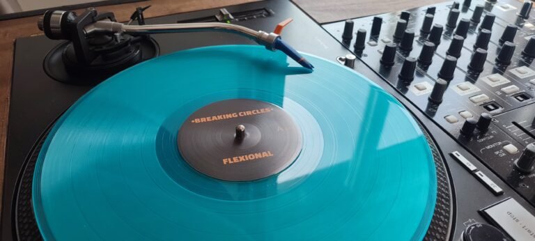 Close-up of turquoise Breaking Circles vinyl on Technics turntable with label visible
