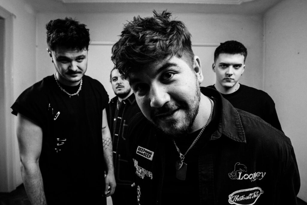 Outflow band black and white portrait with four members looking at the camera.