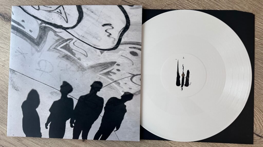 Outflow – Difuz album cover and white vinyl record displayed on wooden surface