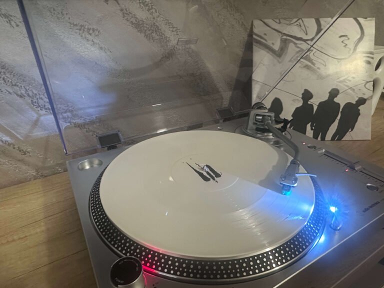 Outflow – Difuz white vinyl playing on turntable with album cover in background.