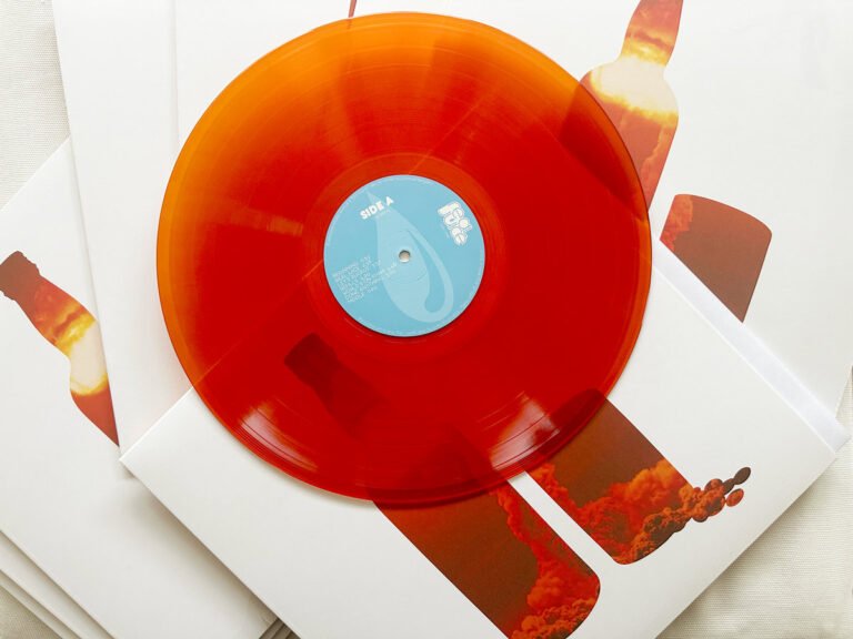 Real Juice – Pimms & Beans orange vinyl record displayed on album sleeve artwork