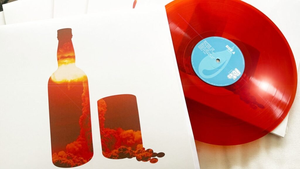 Real Juice – Pimms & Beans album cover with orange vinyl record partially outside sleeve pressed by Mind The Wax